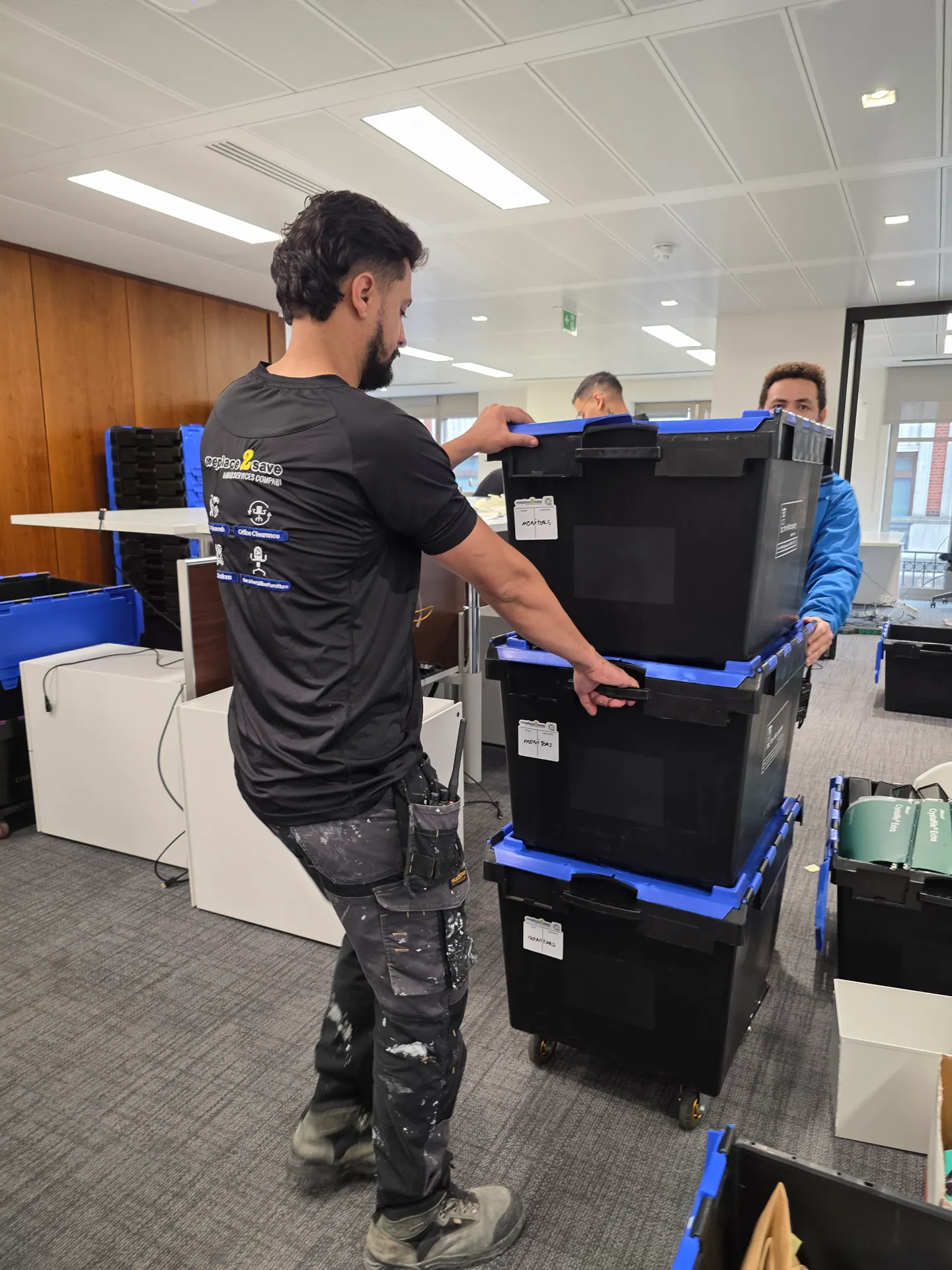 Oneplace2save team moving protected workstation equipment in reusable crates.