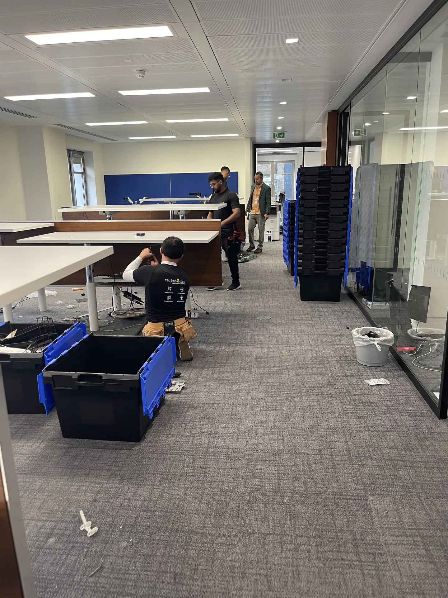 Oneplace2save installation team working across the Evercore office floor.